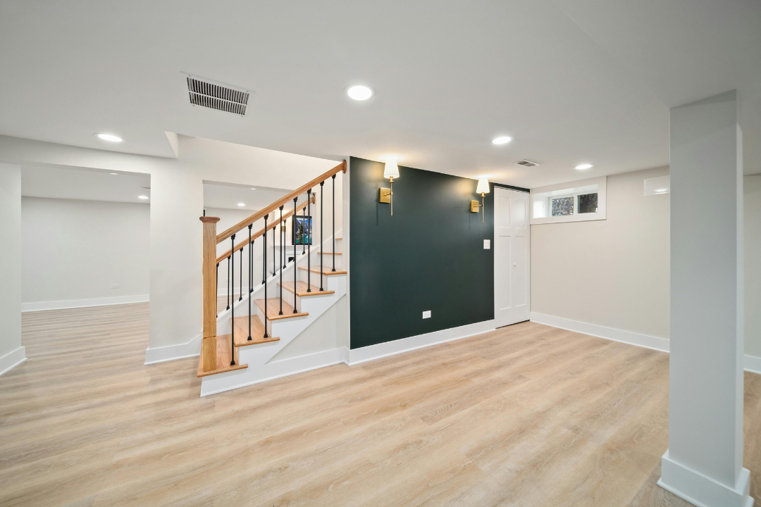 Basement with dark accent wall and new flooring