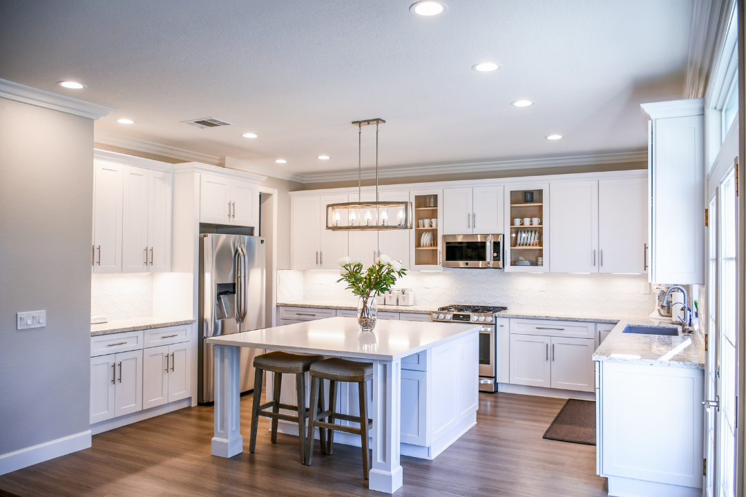 Remodeled white kitchen with island and hardwood floors