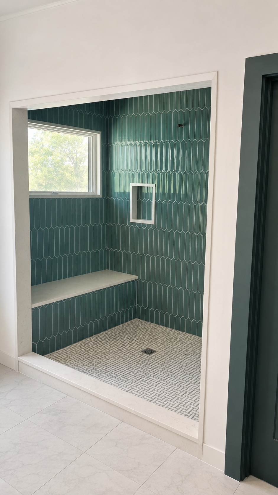Walk-in shower with green picket tile, built-in bench and mosaic tile floor
